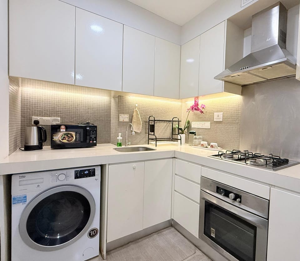 Kitchen or kitchenette, microwave, stove, toaster, washing machine
