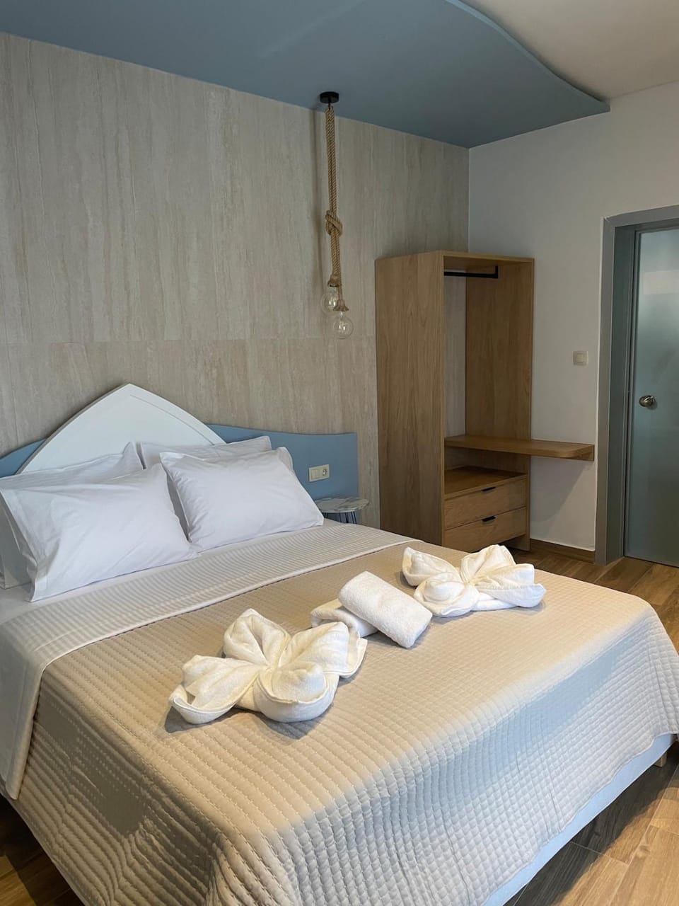 Bed, towels, wardrobe