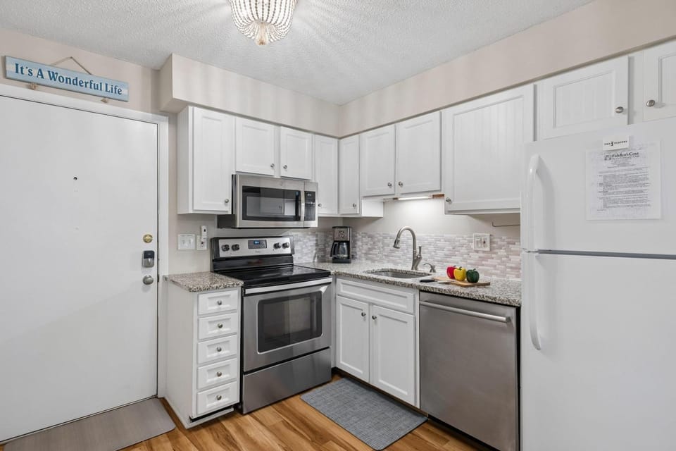 Kitchen or kitchenette, dishwasher, oven, stove