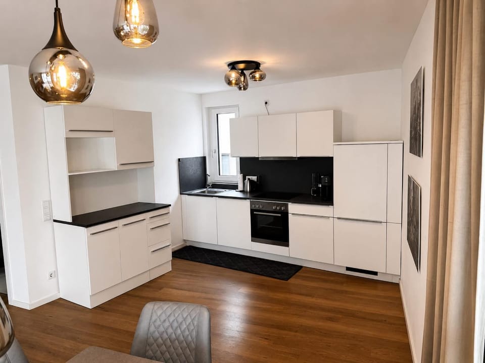Kitchen or kitchenette, dishwasher, oven, stove