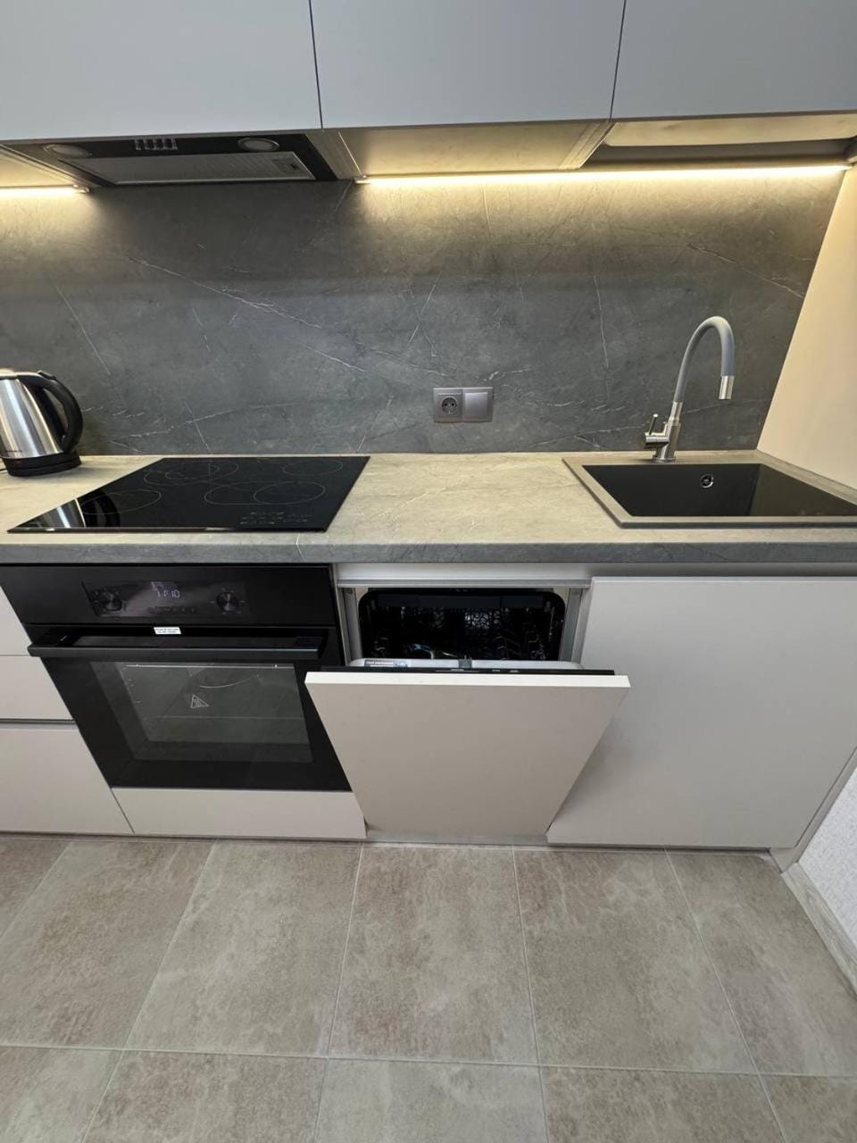 Kitchen or kitchenette, dishwasher, microwave, oven, stove