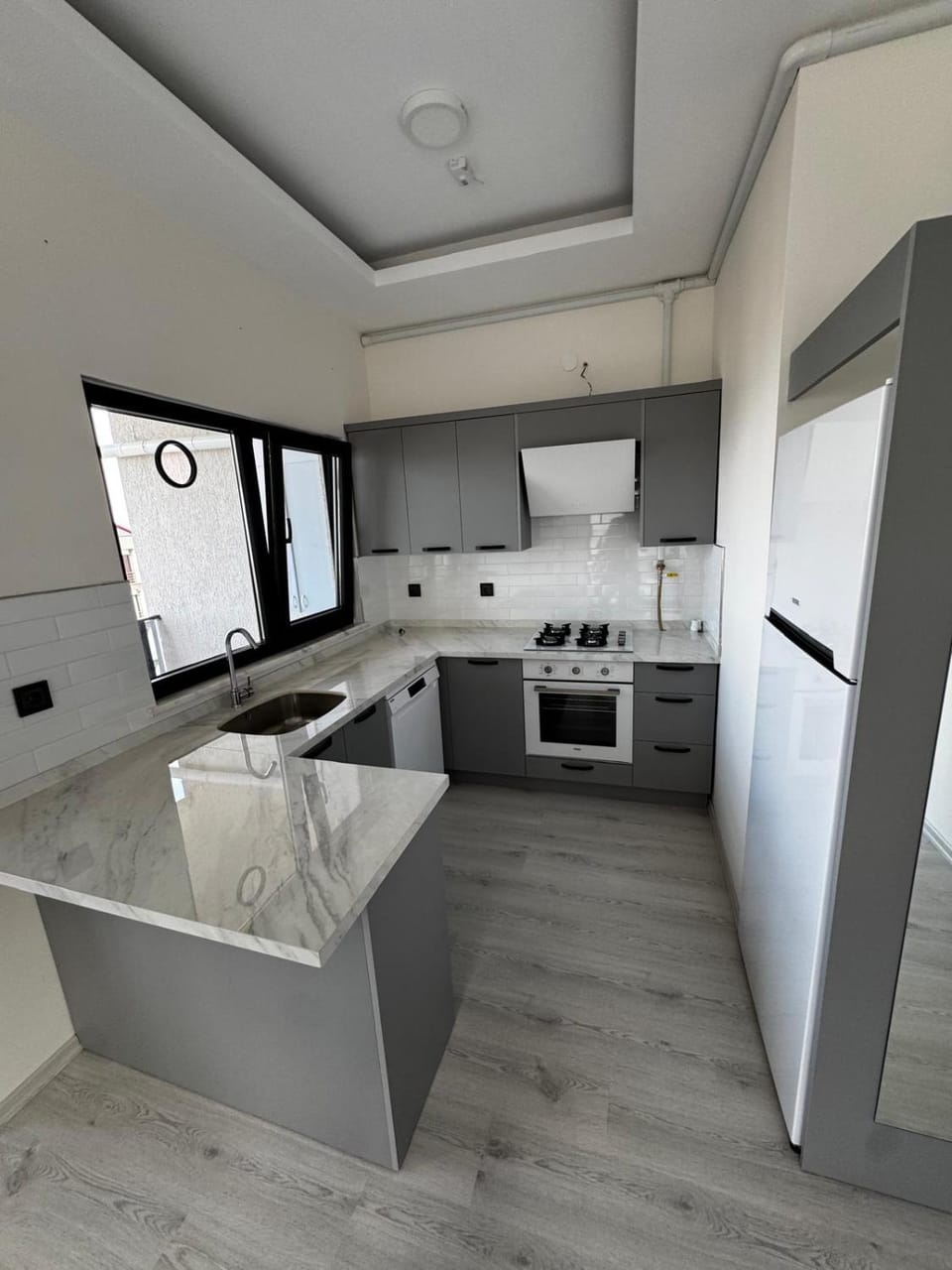 Kitchen or kitchenette, dishwasher, oven, stove