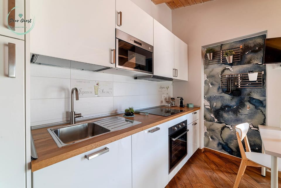 Kitchen or kitchenette, dishwasher, oven, stove