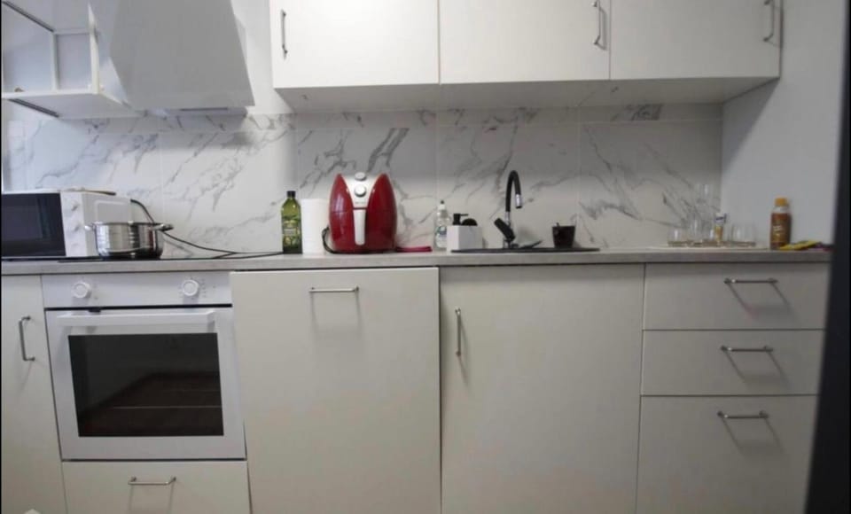 Kitchen or kitchenette, dishwasher, oven, stove