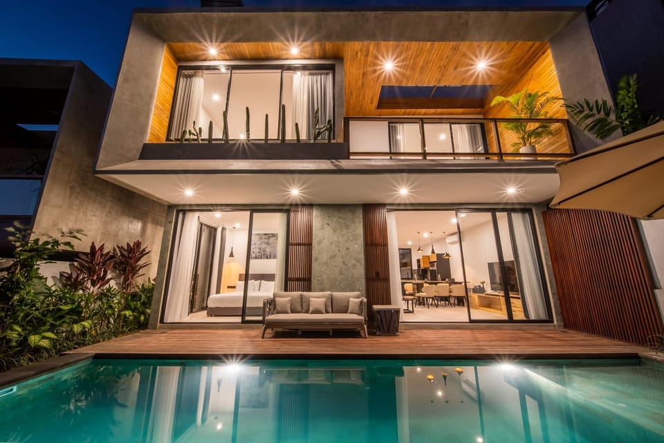 Property building, Patio, Night, View (from property/room), Balcony/Terrace, Living room, Seating area, Pool view, Swimming pool, sunbed