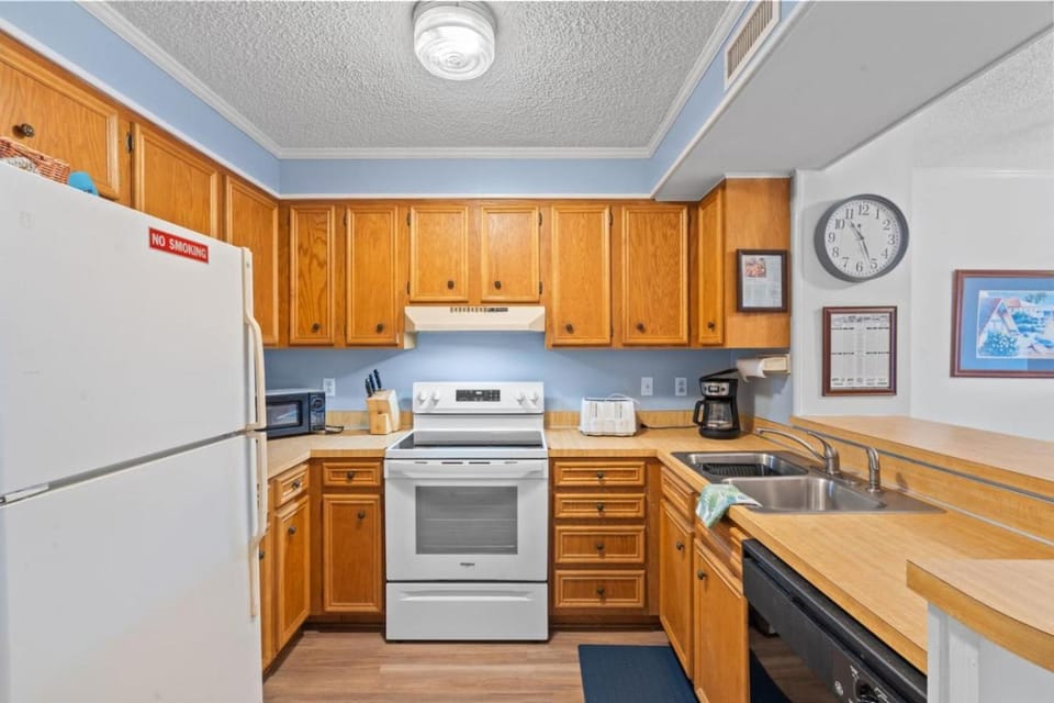Kitchen or kitchenette, dishwasher, oven, stove