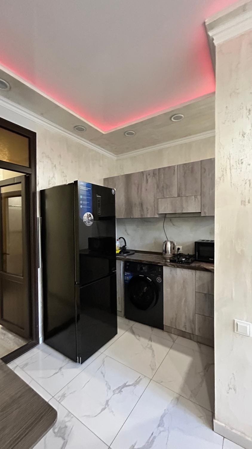 Kitchen or kitchenette, microwave, stove, washing machine
