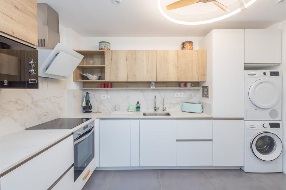 Kitchen or kitchenette, oven, stove, washing machine, dryer