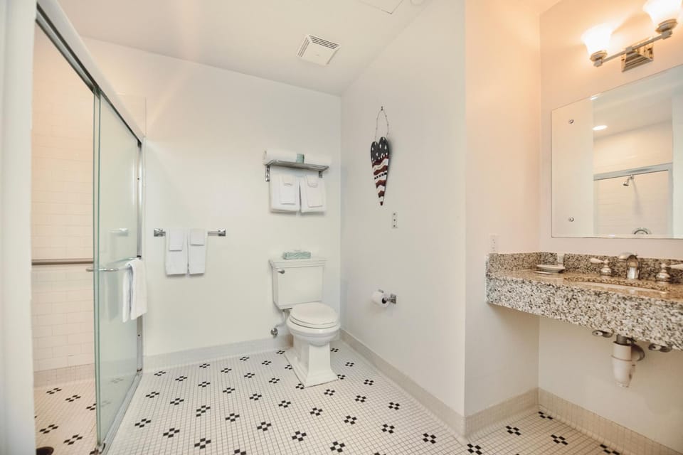 Experience luxury at Captain Suite 219 in Bay Harbor, MI, featuring a cozy bedroom and village view. Apartment in Bay Harbor