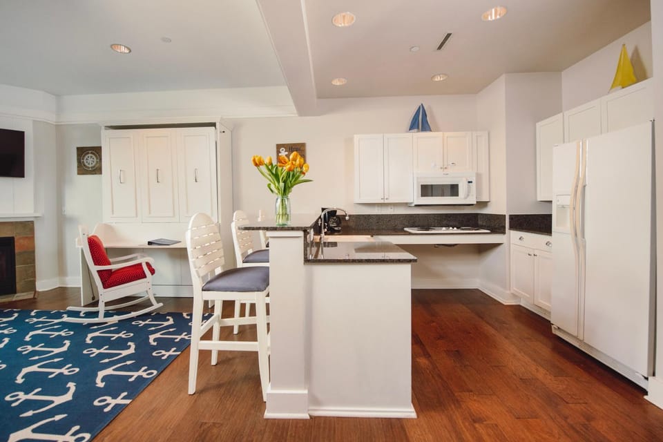 Experience luxury at Captain Suite 219 in Bay Harbor, MI, featuring a cozy bedroom and village view. Apartment in Bay Harbor