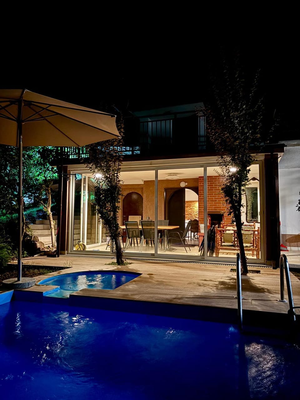 Property building, Patio, Night, Seating area, Pool view, Swimming pool