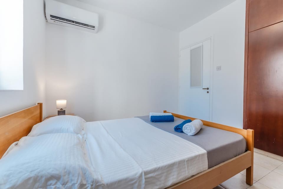 Bed, towels, wardrobe, air conditioner
