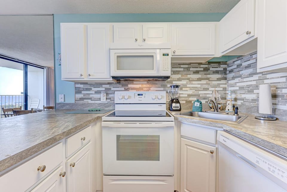 Kitchen or kitchenette, dishwasher, oven, stove