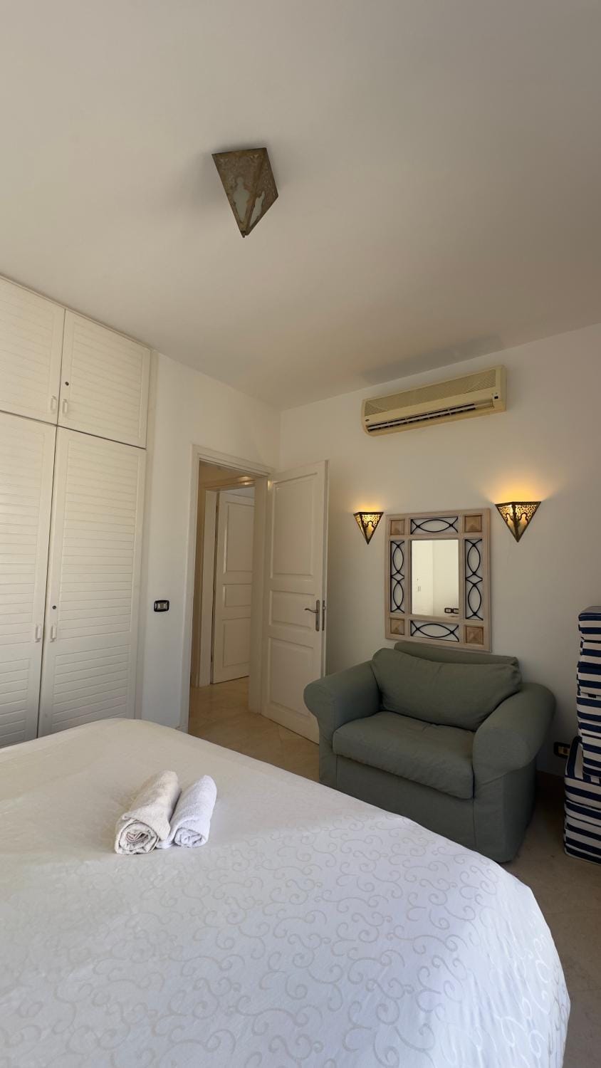 Bed, Seating area, Bedroom, towels, wardrobe, air conditioner