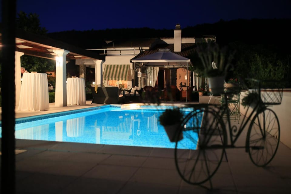 Patio, Patio, Night, People, People, Natural landscape, Summer, Garden, Garden, View (from property/room), Decorative detail, Decorative detail, Seating area, On site, Garden view, Garden view, Mountain view, Pool view, Pool view, Swimming pool, Swimming pool, Family, Family, Inner courtyard view