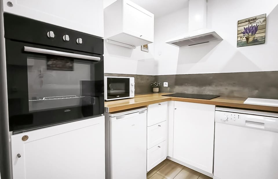 Kitchen or kitchenette, dishwasher, microwave, oven, stove