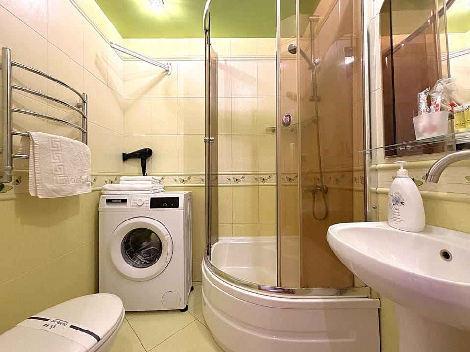 Shower, Toilet, Bathroom, hair dryier, towels, washing machine, dryer