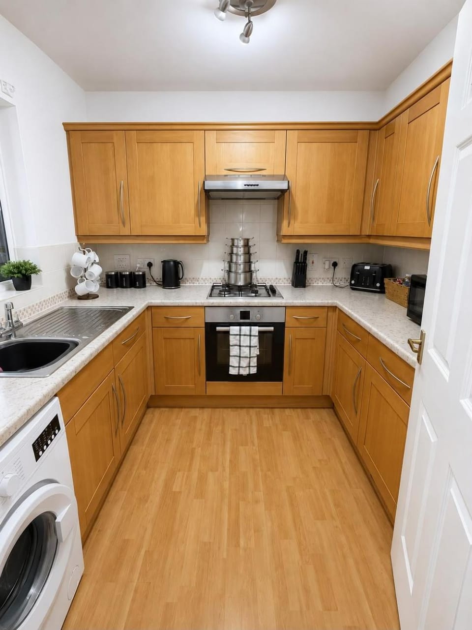 Kitchen or kitchenette, oven, stove, toaster, washing machine