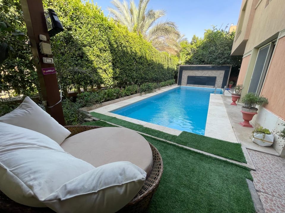 Property building, Patio, Day, Garden, Living room, Seating area, Garden view, Pool view, Swimming pool, sunbed