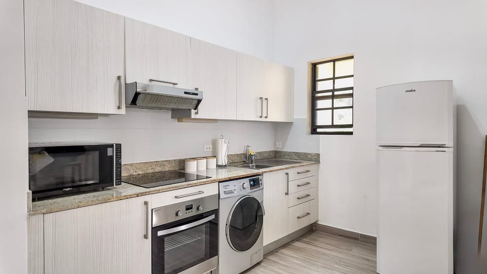 Kitchen or kitchenette, microwave, oven, stove, washing machine