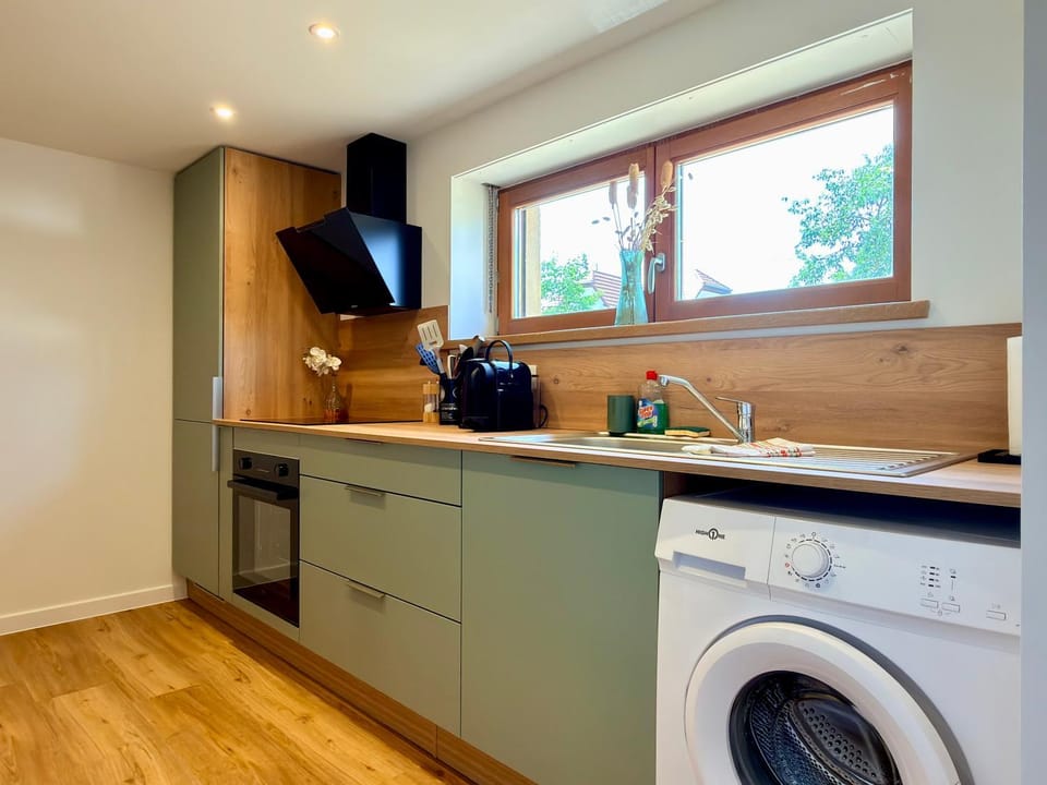 Kitchen or kitchenette, stove, washing machine