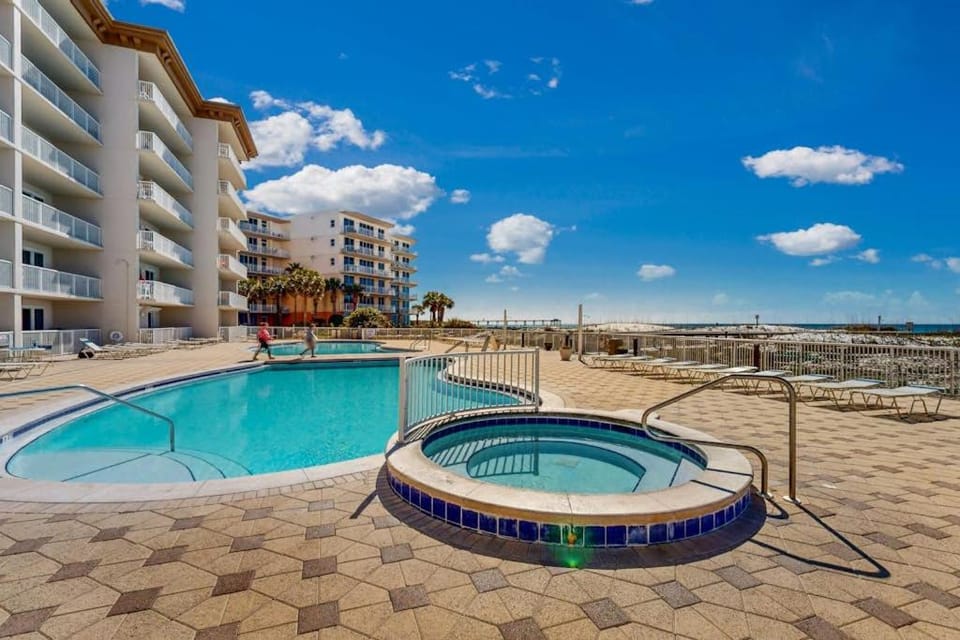 Beachfront condo with beach chairs an umbrella and a pool House in Okaloosa Island