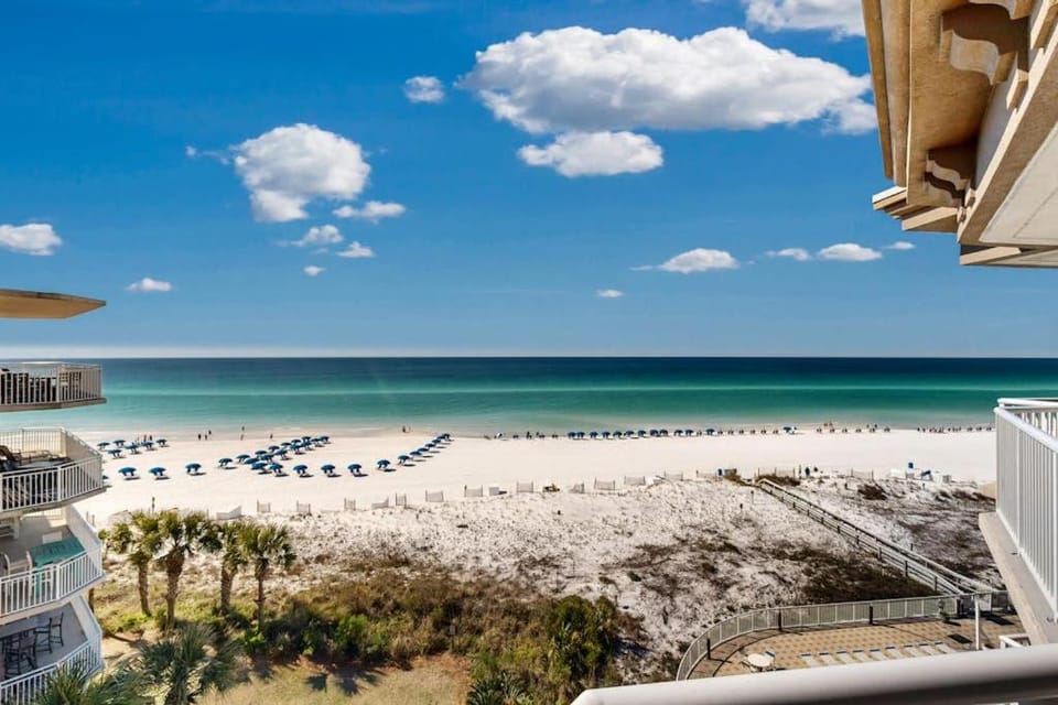 Beachfront condo with beach chairs an umbrella and a pool House in Okaloosa Island