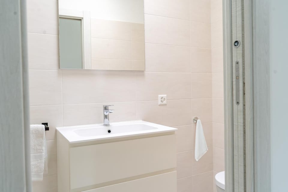 Toilet, Bathroom, hair dryier, towels, washing machine
