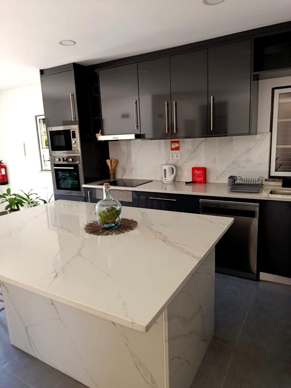 Kitchen or kitchenette, dishwasher, oven, stove