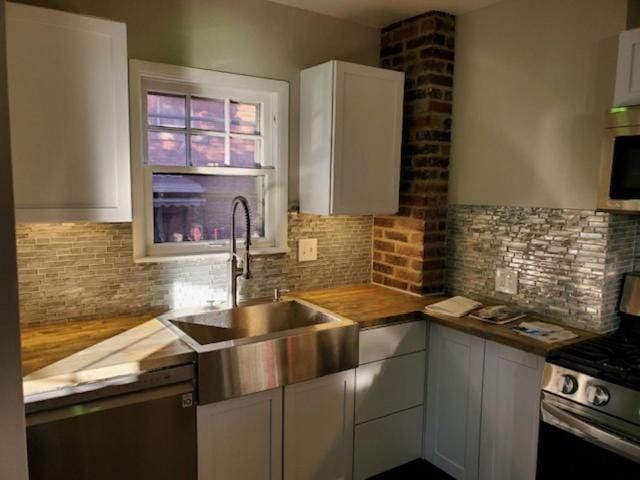 Kitchen or kitchenette, dishwasher, oven, stove