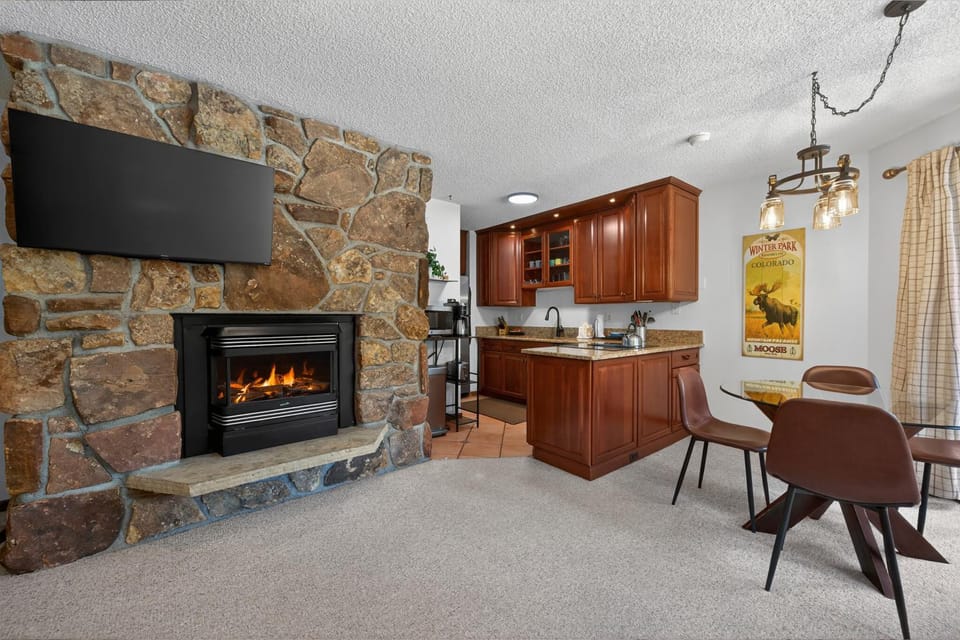 Kitchen or kitchenette, Living room, Seating area, Dining area, fireplace, furniture, microwave, kitchen