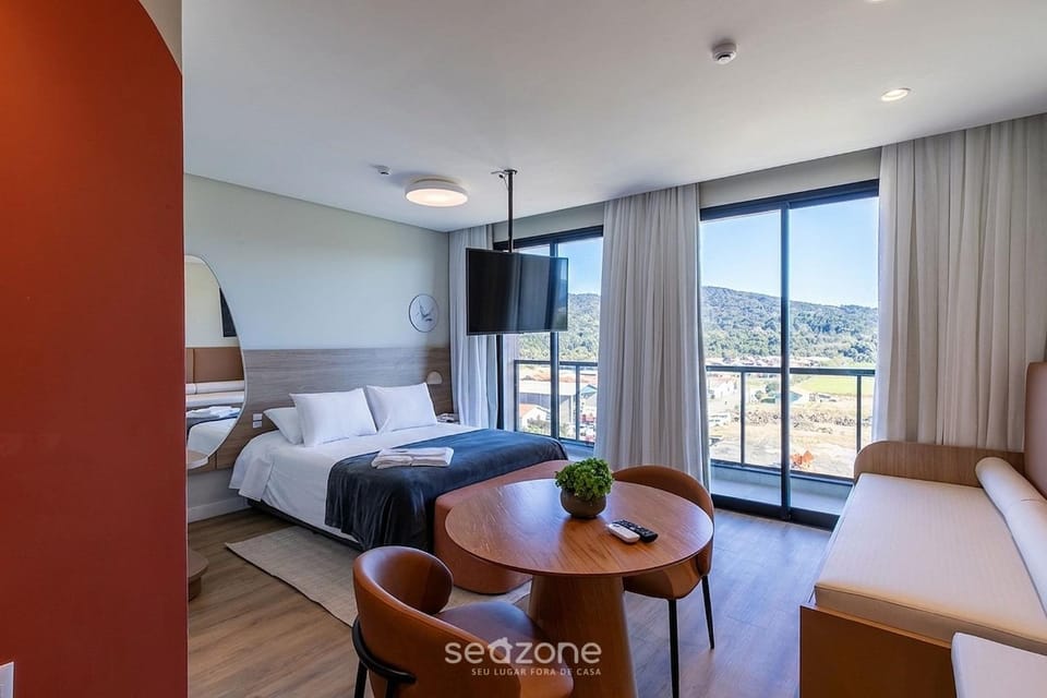 Bed, TV and multimedia, Living room, Seating area, Bedroom, Mountain view