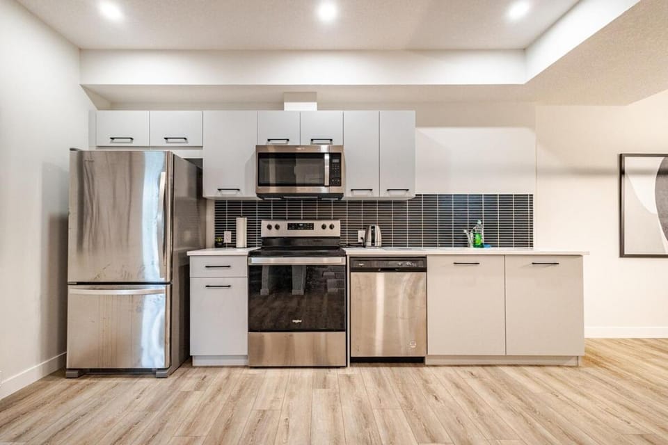 Kitchen or kitchenette, dishwasher, oven, stove