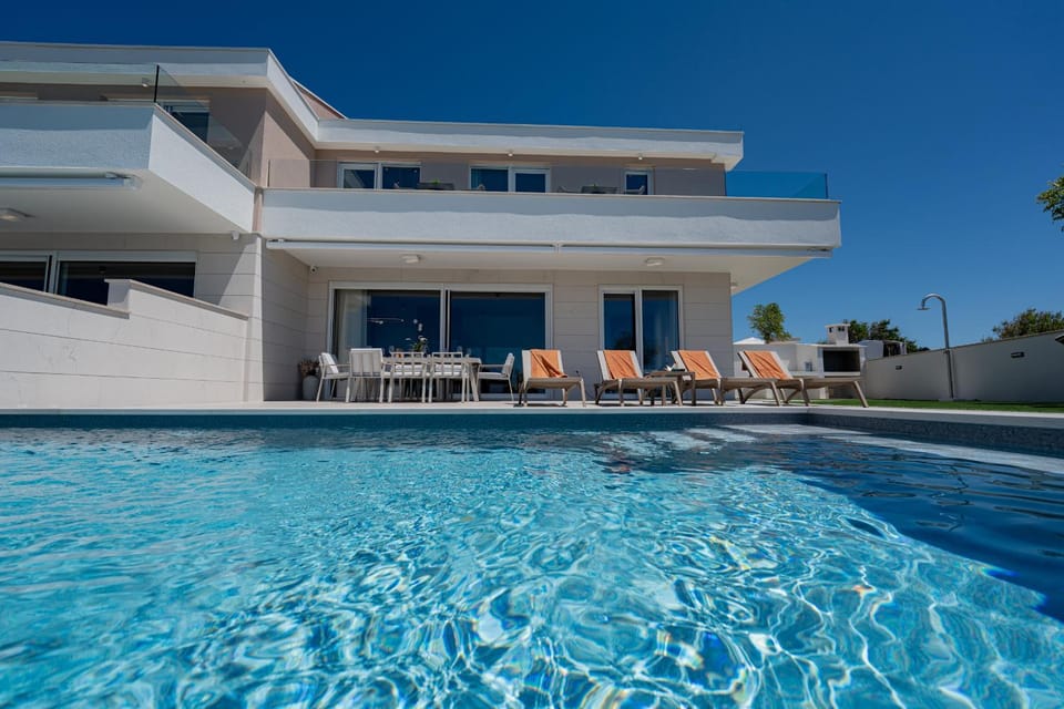 Property building, Patio, Pool view, Swimming pool, sunbed