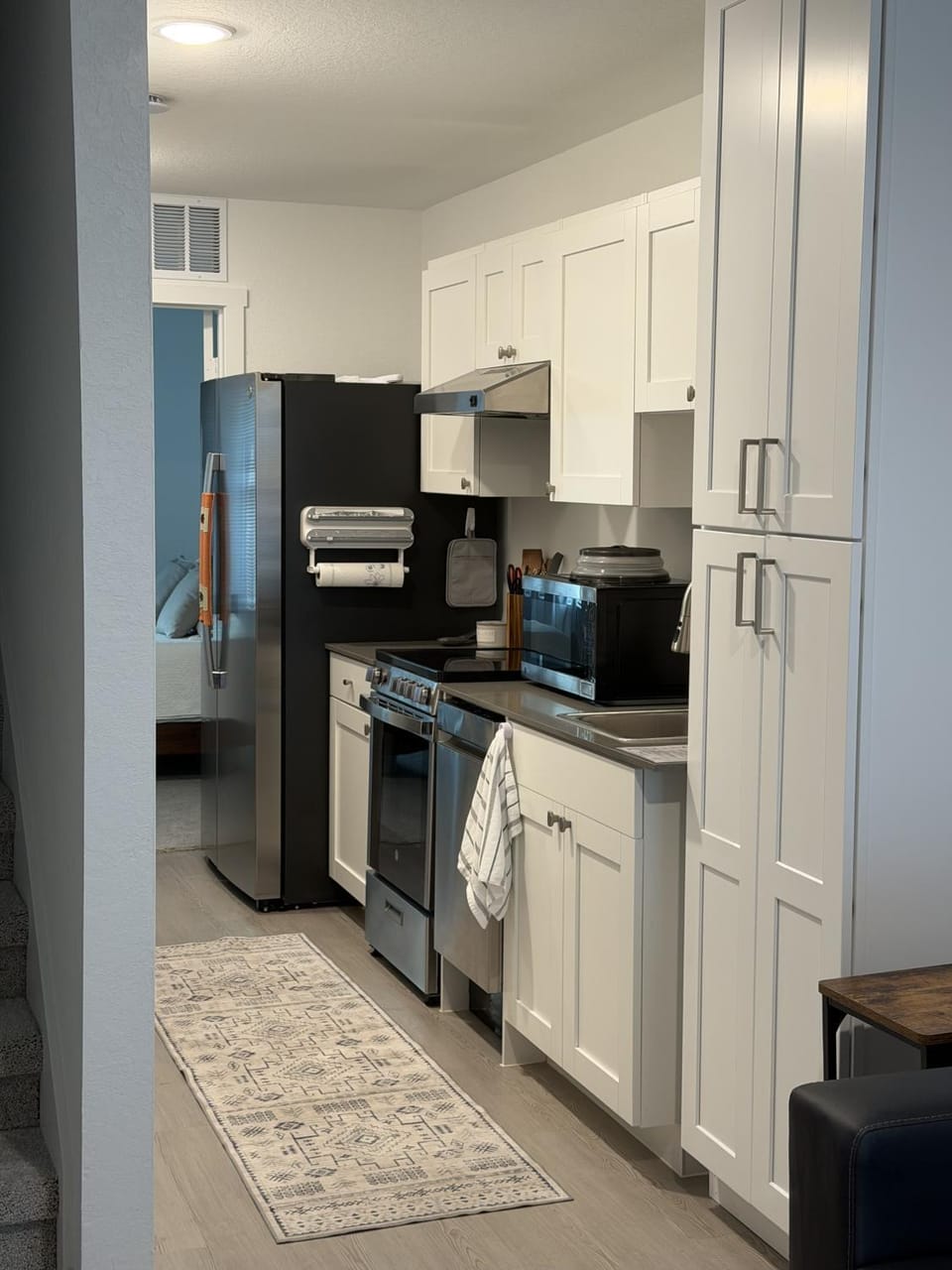 Kitchen or kitchenette, dishwasher, microwave, oven, stove