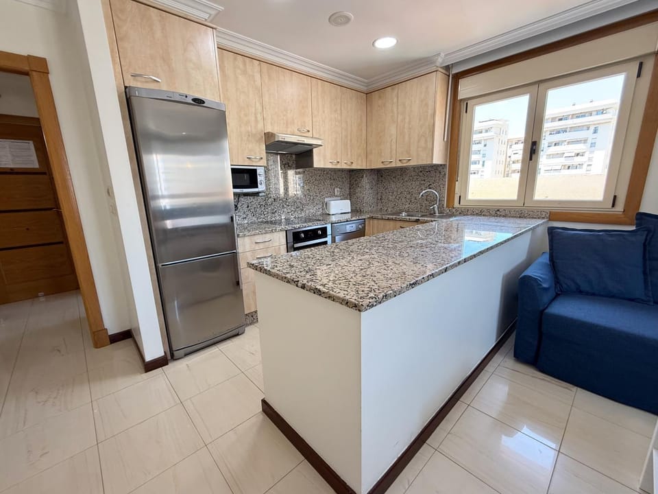 Kitchen or kitchenette, dishwasher, oven, stove