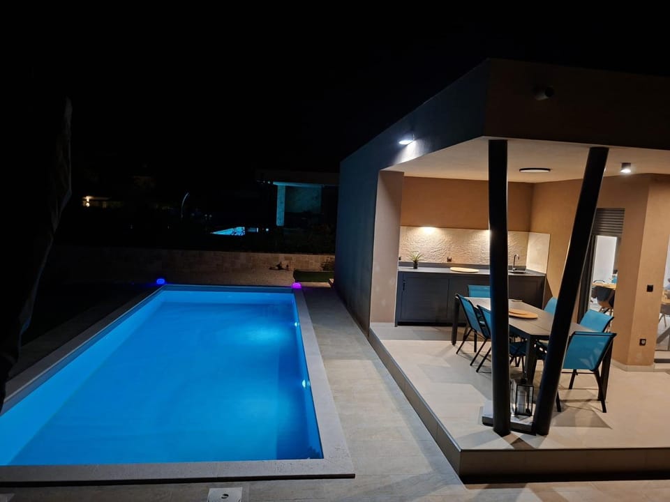 Patio, Night, Dining area, Pool view, Swimming pool, sunbed