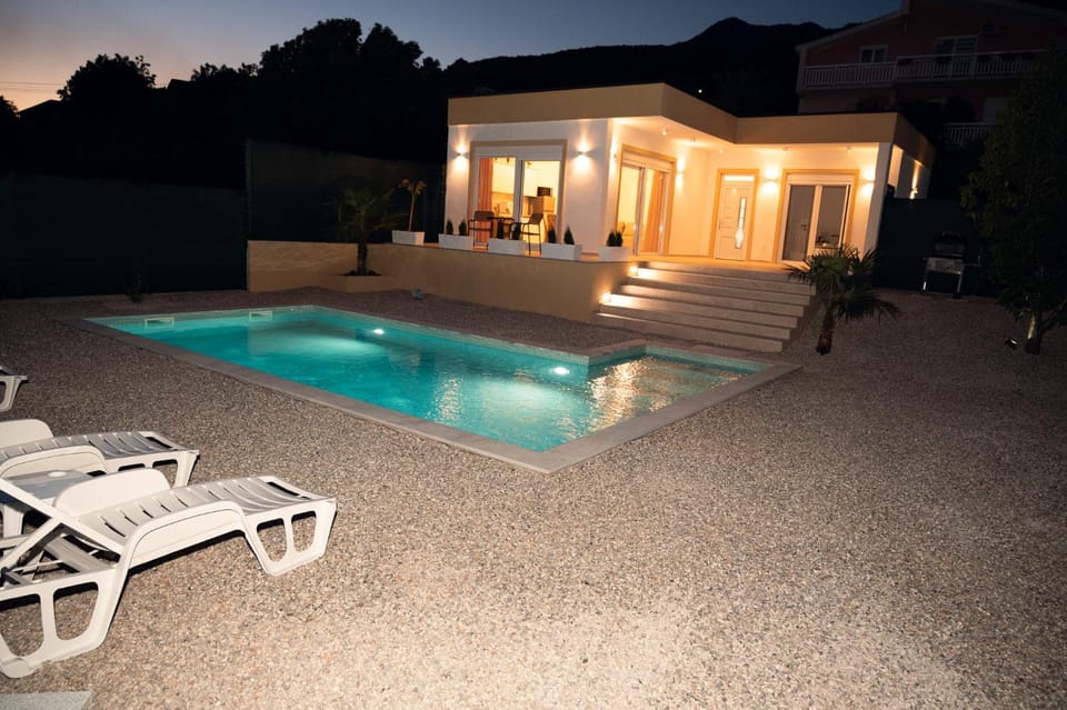 Property building, Patio, Night, Natural landscape, Pool view, Swimming pool, Swimming pool, sunbed