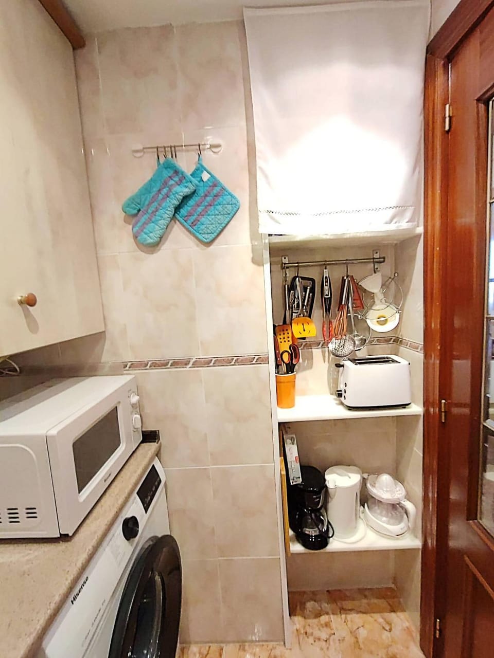 Kitchen or kitchenette, microwave, stove, toaster, washing machine