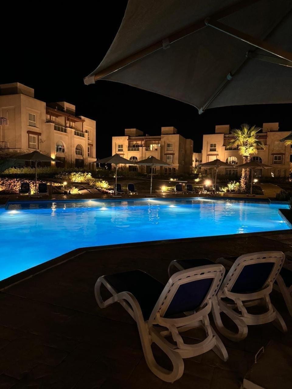 Property building, Patio, Night, Pool view, Swimming pool, sunbed