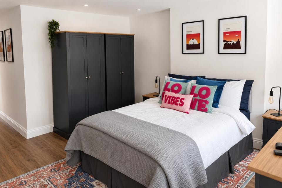 Bed, Decorative detail, Bedroom, flat iron, hair dryier, towels, wardrobe
