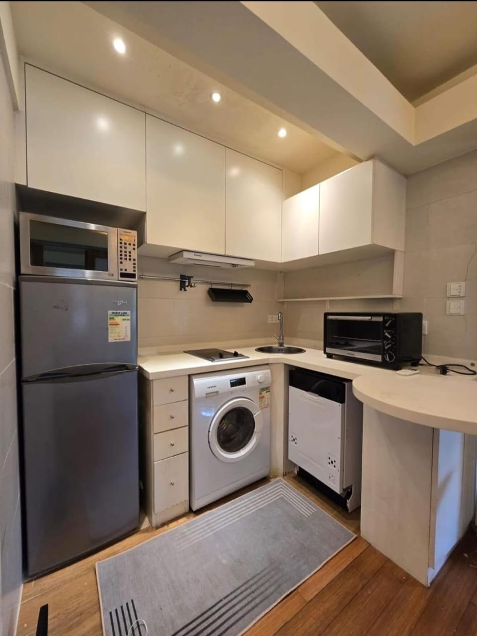 Kitchen or kitchenette, dishwasher, oven, stove, toaster, washing machine, dryer