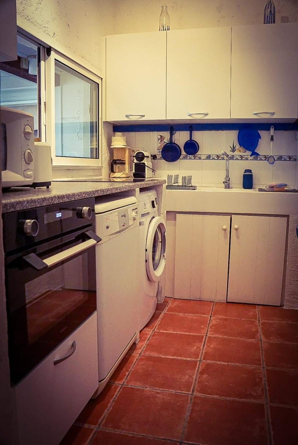 Kitchen or kitchenette, dishwasher, stove, toaster, washing machine
