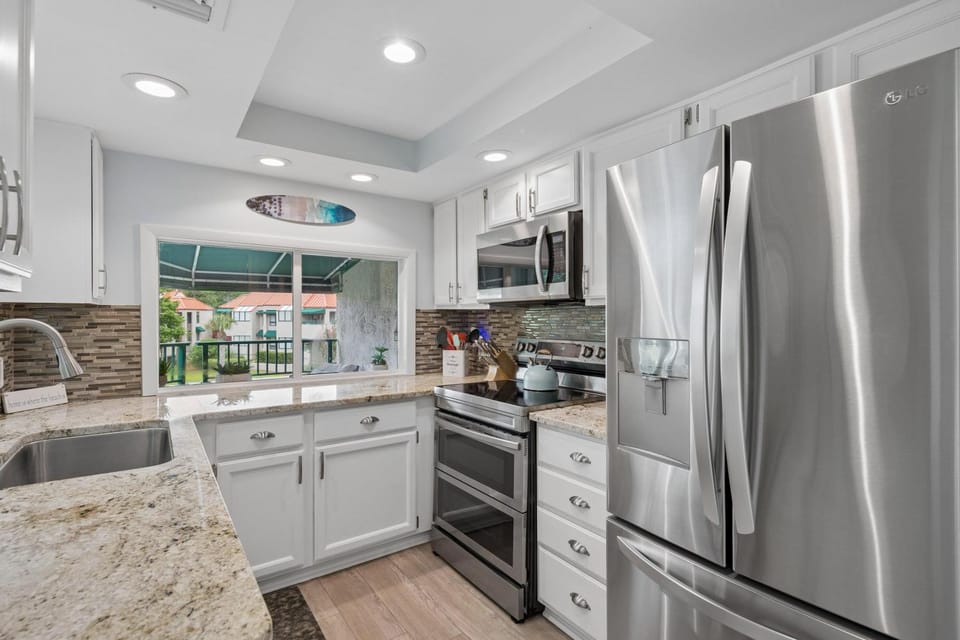 Kitchen or kitchenette, dishwasher, oven, stove