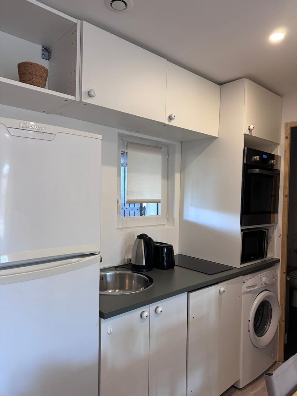 Kitchen or kitchenette, dishwasher, oven, stove, toaster, washing machine