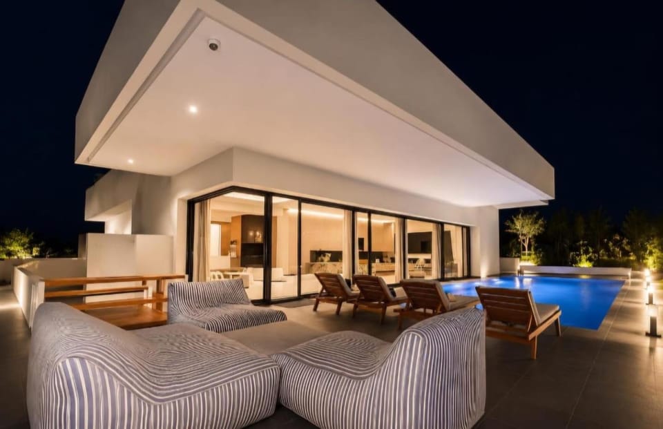 Property building, Patio, Night, Natural landscape, Living room, Pool view, Swimming pool, sunbed
