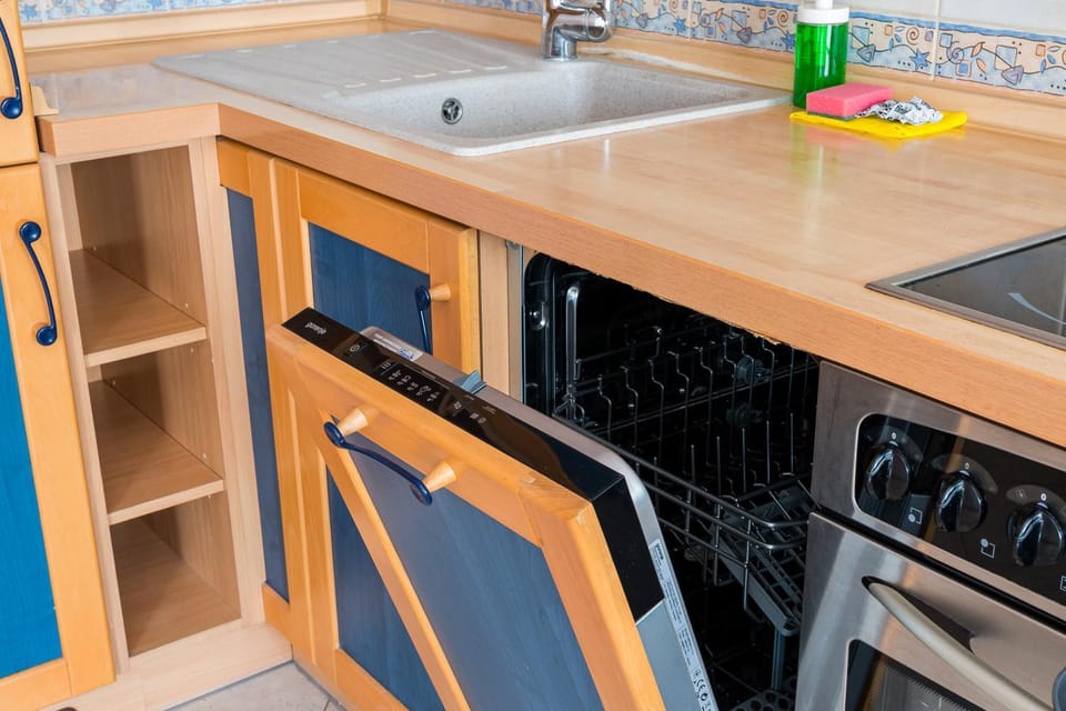 Kitchen or kitchenette, dishwasher, oven, stove