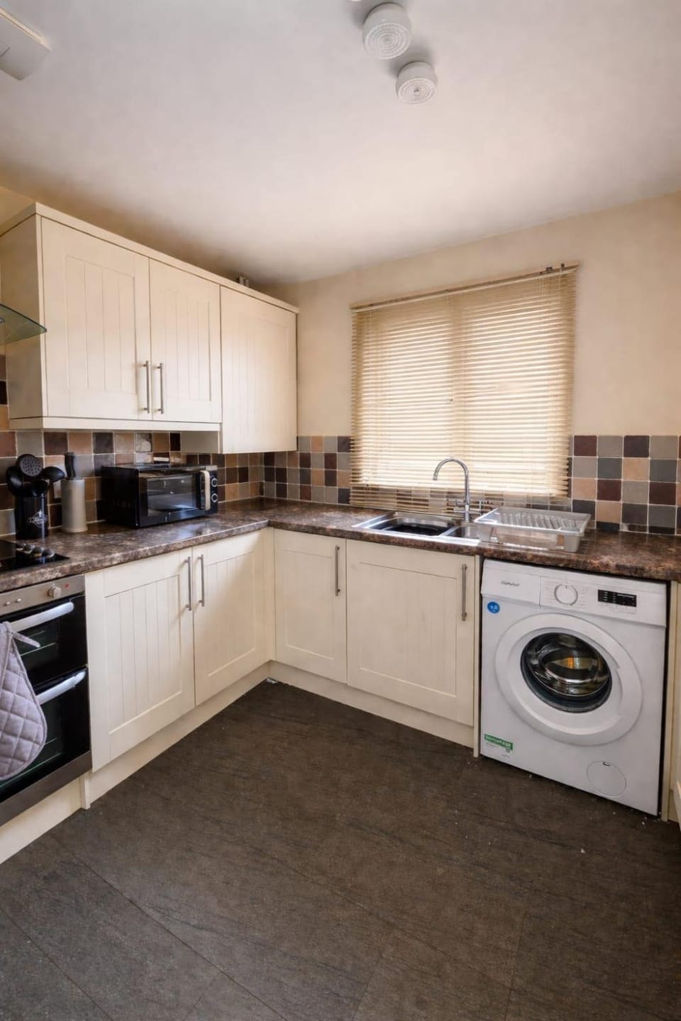 Kitchen or kitchenette, dishwasher, oven, stove