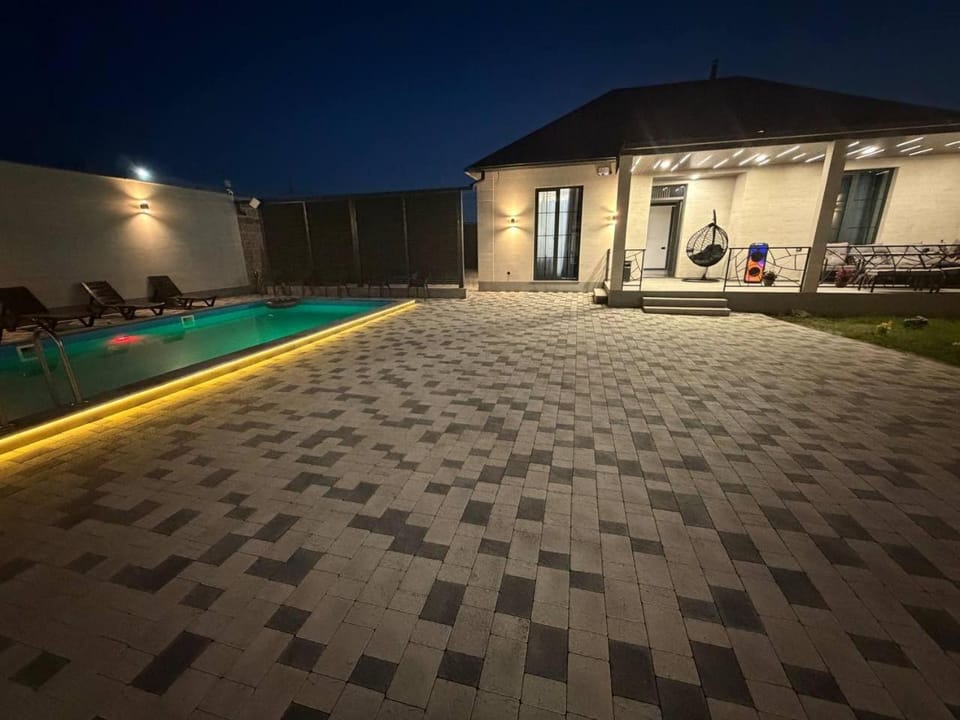 Property building, Patio, Night, Pool view, Swimming pool, sunbed