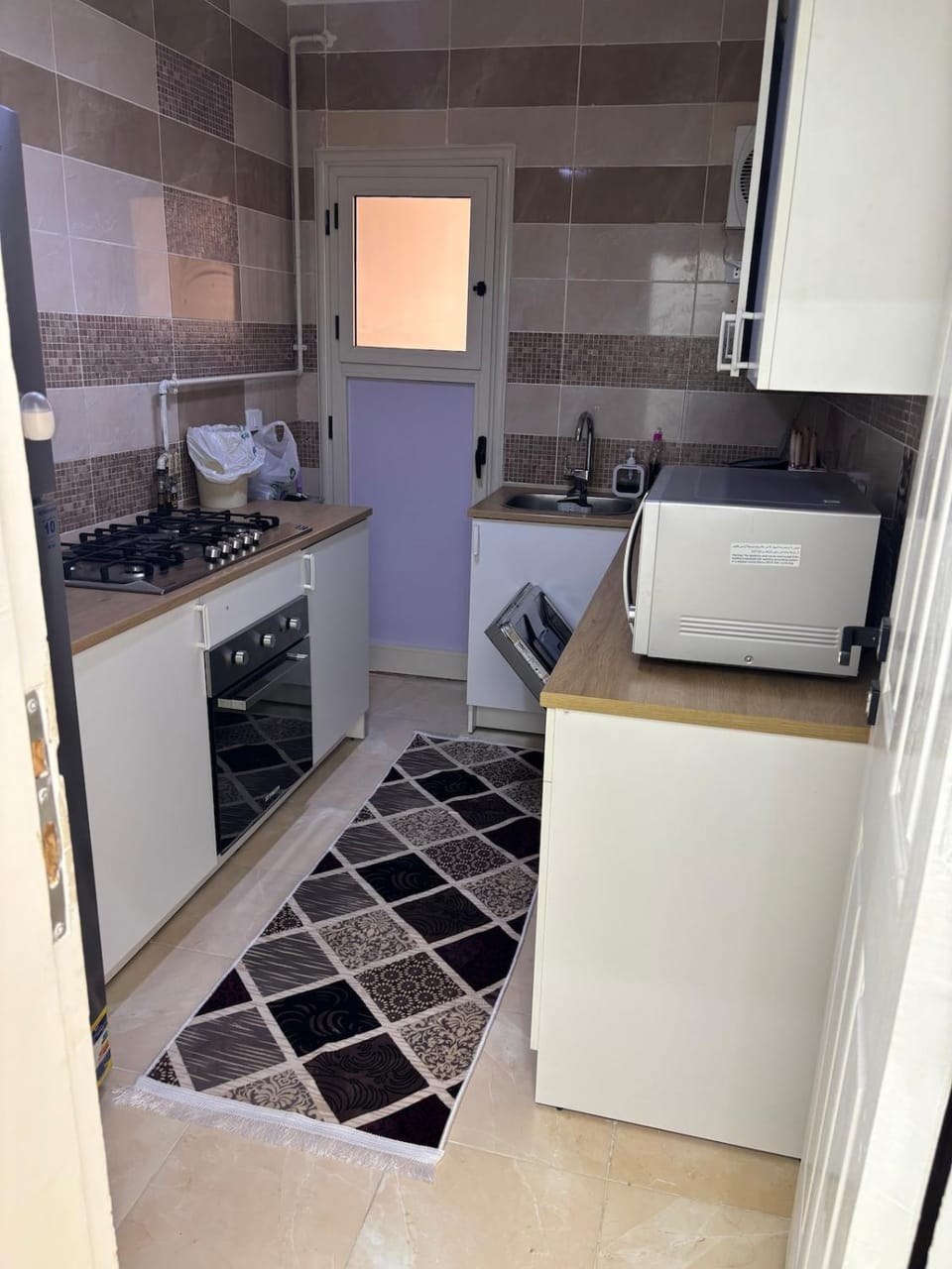Kitchen or kitchenette, dishwasher, oven, stove, toaster
